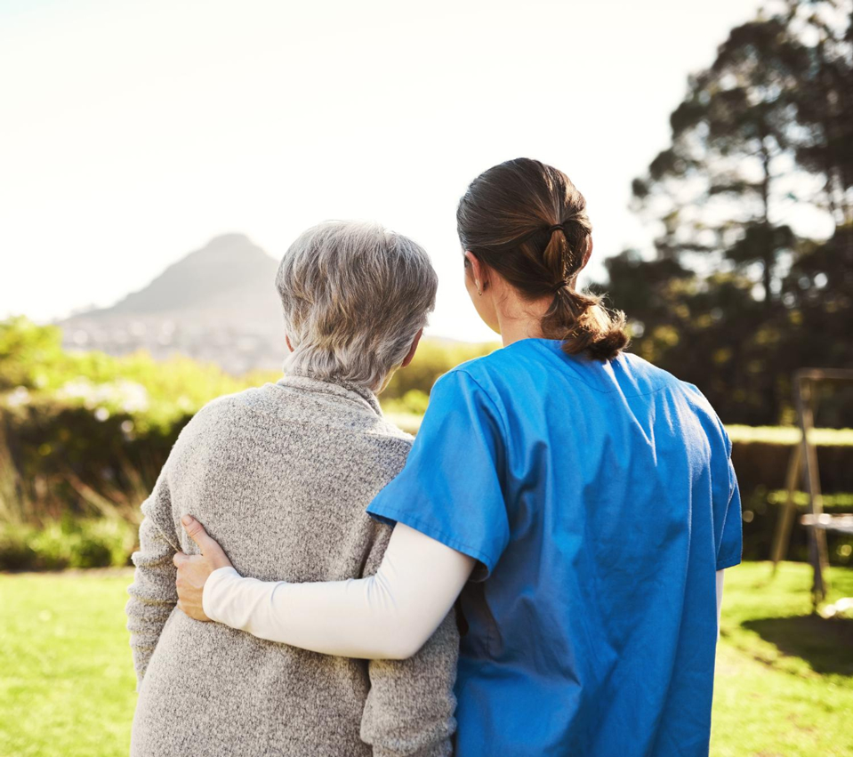 Caregiver and senior facing nature together